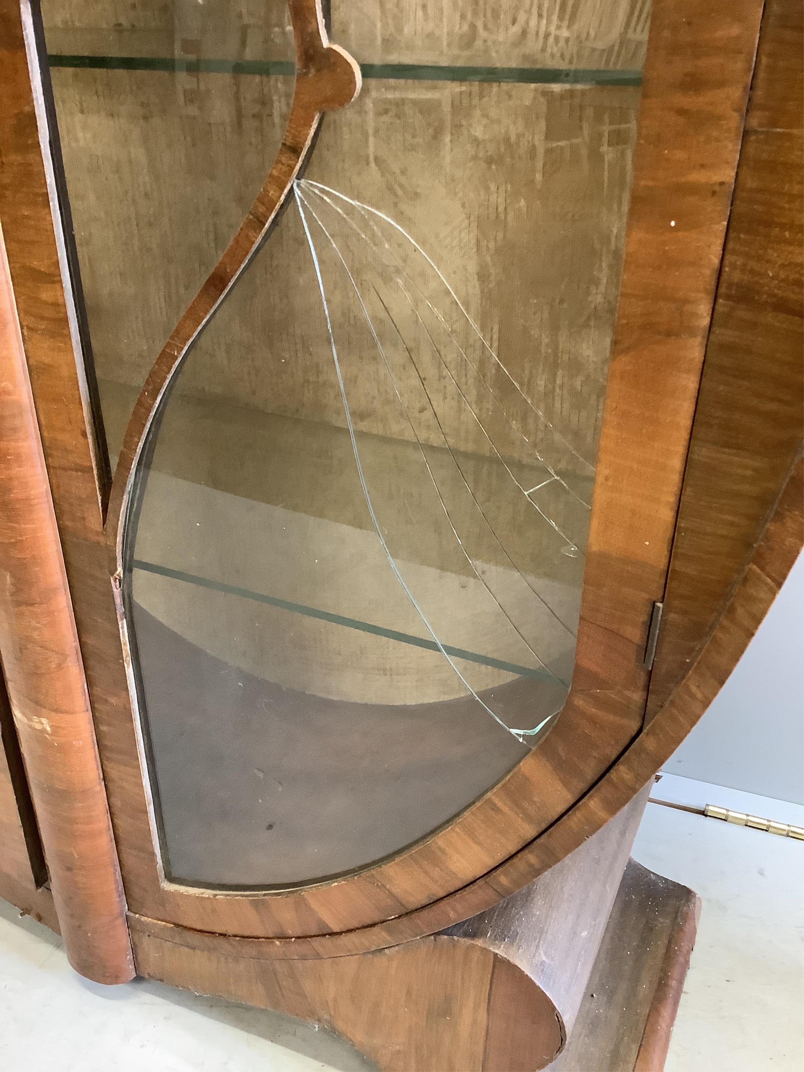 An Art Deco walnut display cabinet, width 98cm, depth 32cm, height 142cm. Condition - poor, one glass pane damaged